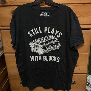 T-Shirt w/slogan “Still Plays With Blocks”.  XL dark gray.  Brand new from Etsy.